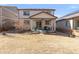 Spacious backyard with a covered patio, perfect for outdoor dining and relaxation, surrounded by a well-maintained lawn at 5032 S Valdai Way, Aurora, CO 80015