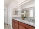 Bathroom featuring granite countertop with double sinks, stylish fixtures and large mirror at 5032 S Valdai Way, Aurora, CO 80015