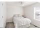 Bedroom featuring plush carpet, a large window, and neutral decor at 5032 S Valdai Way, Aurora, CO 80015