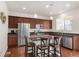 Modern kitchen with stainless steel appliances, granite countertops, and a breakfast bar at 5032 S Valdai Way, Aurora, CO 80015