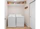 Well-organized laundry room with washer, dryer, storage shelves and tile floor at 5032 S Valdai Way, Aurora, CO 80015