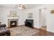 Cozy living room with a fireplace, dark wood floors, and lots of natural light at 5032 S Valdai Way, Aurora, CO 80015