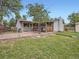 Backyard featuring a patio with cooking area, fencing, a lawn, and a wood-paneled exterior at 15642 E Eldorado Dr, Aurora, CO 80013