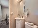 Bathroom featuring a vanity sink, toilet, and a round mirror at 15642 E Eldorado Dr, Aurora, CO 80013