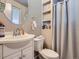 Bathroom featuring a vanity sink, toilet, shelving and shower with curtain at 15642 E Eldorado Dr, Aurora, CO 80013