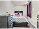 Simple bedroom with gray walls, carpet, and furniture, featuring a bed and window with curtains at 15642 E Eldorado Dr, Aurora, CO 80013