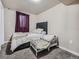 Comfortable bedroom with neutral walls and carpet, showcasing a bed, crib, and window with curtains at 15642 E Eldorado Dr, Aurora, CO 80013