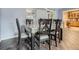 Light-filled dining room features wood floors and dining set for six people at 15642 E Eldorado Dr, Aurora, CO 80013