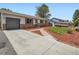 Inviting home with a well-maintained front yard, long driveway, and a detached garage at 15642 E Eldorado Dr, Aurora, CO 80013