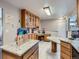 Bright eat-in kitchen featuring light wood cabinets, granite countertops, with an adjoining living area at 15642 E Eldorado Dr, Aurora, CO 80013