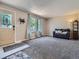 Bright living room featuring neutral walls, plush carpet, and a decorative front door with stained-glass accent at 15642 E Eldorado Dr, Aurora, CO 80013