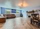 Open living room with fireplace, wood-look tile floors, and lots of natural light at 15642 E Eldorado Dr, Aurora, CO 80013