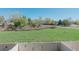 Backyard with views of a grassy field and mature trees in a peaceful setting at 9671 W Chatfield Ave # B, Littleton, CO 80128