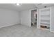 Basement area featuring tile flooring and a doorway leading to an additional room at 9671 W Chatfield Ave # B, Littleton, CO 80128