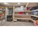 Unfinished basement provides ample storage with built-in shelving and a chest freezer at 9671 W Chatfield Ave # B, Littleton, CO 80128