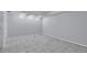 Large basement area with tile floor and neutral colors at 9671 W Chatfield Ave # B, Littleton, CO 80128