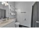 Neutral bathroom with modern shelving and fixtures with a shower with gray curtain at 9671 W Chatfield Ave # B, Littleton, CO 80128