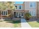 Charming townhome with stone accents, beige siding, and well-manicured landscaping at 9671 W Chatfield Ave # B, Littleton, CO 80128
