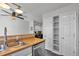 Bright kitchen featuring stainless steel appliances and wood countertops, complemented by modern lighting at 9671 W Chatfield Ave # B, Littleton, CO 80128
