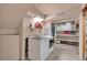 Well-lit laundry room featuring modern appliances and ample storage space at 9671 W Chatfield Ave # B, Littleton, CO 80128