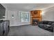 Spacious living room featuring a fireplace, large window, and access to front entrance at 9671 W Chatfield Ave # B, Littleton, CO 80128