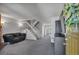 Cozy living room featuring neutral colors, a staircase, and access to the kitchen at 9671 W Chatfield Ave # B, Littleton, CO 80128
