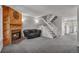 Comfortable living room with fireplace, staircase, and seamless flow to the kitchen at 9671 W Chatfield Ave # B, Littleton, CO 80128