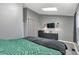 Main bedroom with a skylight, TV, dark curtains, and gray walls at 9671 W Chatfield Ave # B, Littleton, CO 80128