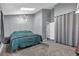 Cozy main bedroom features a skylight, carpet flooring, and stylish modern light fixture at 9671 W Chatfield Ave # B, Littleton, CO 80128