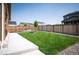 Large, flat backyard with a well maintained lawn, a fence, a young tree, and a patio at 27790 E 9Th Pl, Aurora, CO 80018