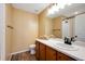 Well lit bathroom featuring a toilet, sink with vanity, white countertops, and updated wood-look flooring at 27790 E 9Th Pl, Aurora, CO 80018