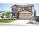 Charming two-story home featuring a two-car garage, covered porch, and well-manicured lawn at 27790 E 9Th Pl, Aurora, CO 80018