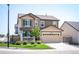 Charming two-story home featuring a two-car garage, covered porch, and well-manicured lawn at 27790 E 9Th Pl, Aurora, CO 80018