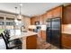 Bright kitchen with wood floors, cabinets, stainless appliances, and a large island perfect for entertaining, with sliding glass door access at 27790 E 9Th Pl, Aurora, CO 80018