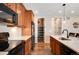 Updated kitchen featuring wood cabinets, stainless steel appliances, and a large island, with direct access to a spacious pantry at 27790 E 9Th Pl, Aurora, CO 80018