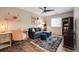 Cozy living room features a comfortable blue sofa, ceiling fan, and stylish decor at 27790 E 9Th Pl, Aurora, CO 80018