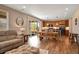 Open-concept living area with hardwood floors, natural light, and dining table at 27790 E 9Th Pl, Aurora, CO 80018