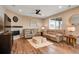 Cozy living room area with hardwood floors, ceiling fan, and neutral walls at 27790 E 9Th Pl, Aurora, CO 80018