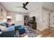 Comfortable living area with a plush sectional, TV, and a decorative area rug at 27790 E 9Th Pl, Aurora, CO 80018