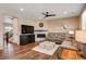 Living room area with hardwood floors, fireplace, ceiling fan and neutral walls at 27790 E 9Th Pl, Aurora, CO 80018
