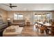 Open-concept living room with ceiling fan, hardwood floors, and dining area at 27790 E 9Th Pl, Aurora, CO 80018
