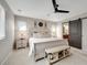 Serene main bedroom with a white wooden bed frame, sliding barn door and ceiling fan at 27790 E 9Th Pl, Aurora, CO 80018