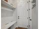 A conveniently located mud room featuring a bench, coat hooks, and storage shelves for organized living at 27790 E 9Th Pl, Aurora, CO 80018
