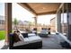 Relaxing outdoor patio with comfortable seating, a modern fire pit, and view of the fenced backyard at 27790 E 9Th Pl, Aurora, CO 80018