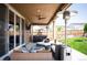 Covered patio with a ceiling fan, mounted television, hot tub, and comfortable seating area at 27790 E 9Th Pl, Aurora, CO 80018