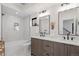 Bright modern bathroom featuring double vanity, and a shower-tub with marble tiling at 1727 Lowell Blvd, Denver, CO 80204
