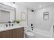 Clean bathroom with a tub and shower and a light wood vanity at 1727 Lowell Blvd, Denver, CO 80204