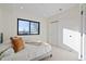 Bright bedroom featuring a large window, neutral tones, and a closet with sliding doors at 1727 Lowell Blvd, Denver, CO 80204