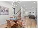 Bright dining area with glass table adjacent to an open concept living space and staircase at 1727 Lowell Blvd, Denver, CO 80204