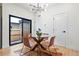 Bright dining area with a glass table, stylish chairs, modern lighting, and access to the outdoors at 1727 Lowell Blvd, Denver, CO 80204